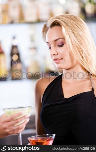Close-up of a young woman holding a cocktail
