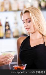 Close-up of a young woman holding a cocktail