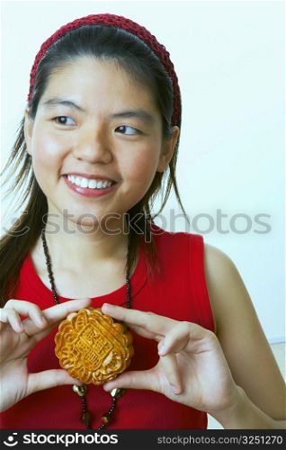 Close-up of a young woman holding a cookie
