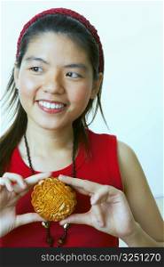 Close-up of a young woman holding a cookie