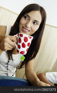 Close-up of a young woman holding a cup of tea