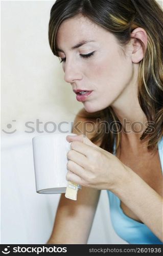 Close-up of a young woman holding a cup of tea