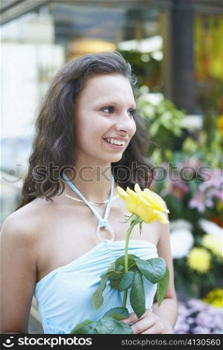 Close-up of a young woman holding a flower