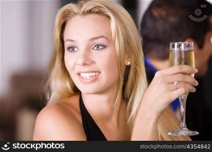 Close-up of a young woman holding a glass of champagne