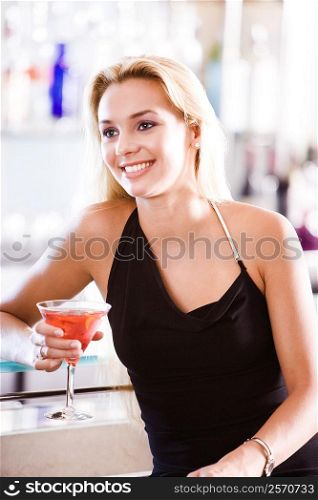 Close-up of a young woman holding a glass of martini