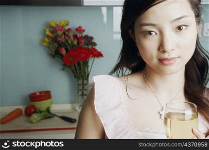 Close-up of a young woman holding a glass of white wine