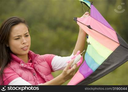 Close-up of a young woman holding a kite