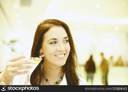 Close-up of a young woman holding a martini