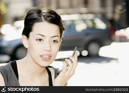 Close-up of a young woman holding a mobile phone