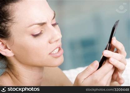 Close-up of a young woman holding a mobile phone