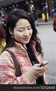 Close-up of a young woman holding a mobile phone