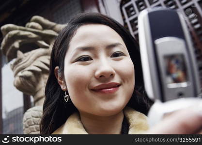 Close-up of a young woman holding a mobile phone