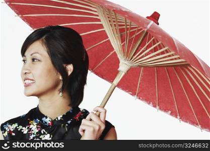Close-up of a young woman holding a parasol