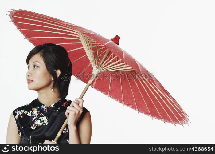 Close-up of a young woman holding a parasol