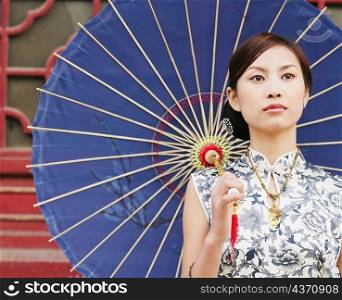 Close-up of a young woman holding a parasol
