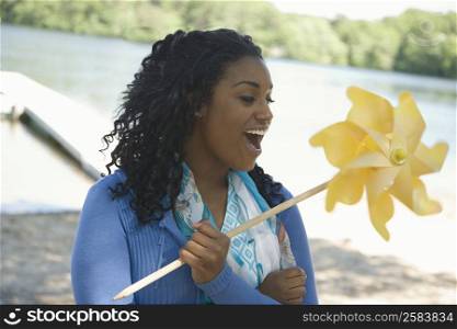 Close-up of a young woman holding a pinwheel