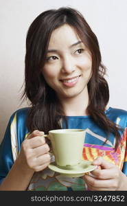 Close-up of a young woman holding a tea cup