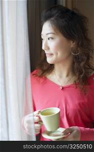 Close-up of a young woman holding a tea cup