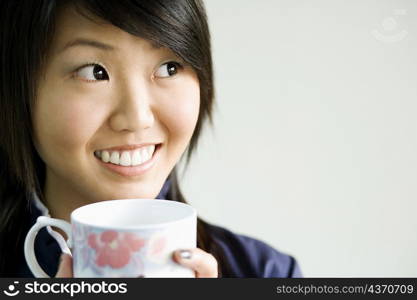 Close-up of a young woman holding a tea cup