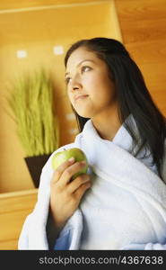 Close-up of a young woman holding an apple