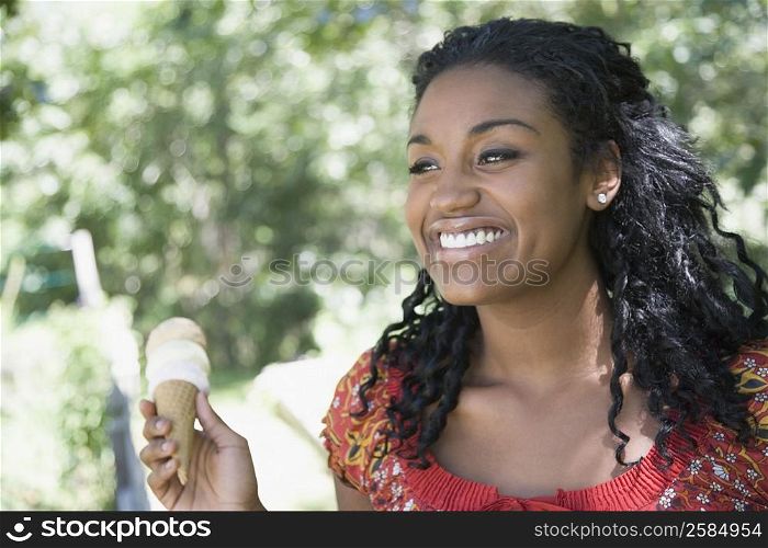 Close-up of a young woman holding an ice cream cone