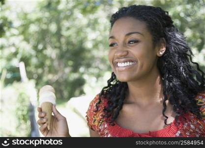 Close-up of a young woman holding an ice cream cone