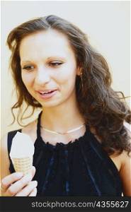 Close-up of a young woman holding an ice-cream cone