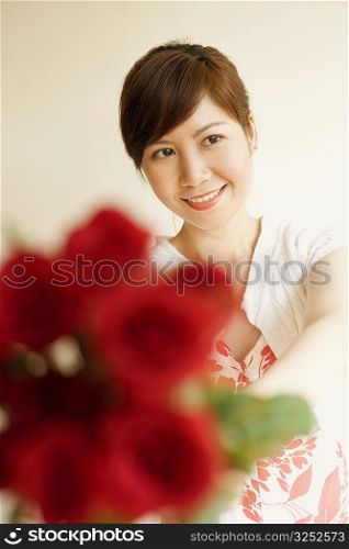 Close-up of a young woman holding bunch of roses