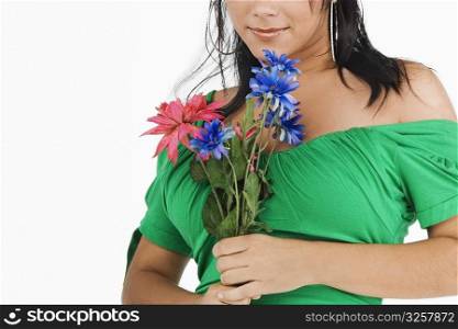 Close-up of a young woman holding flowers and smiling