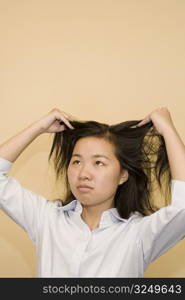 Close-up of a young woman holding her hair