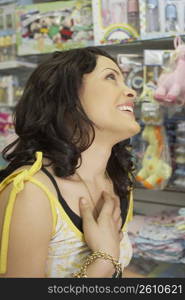 Close-up of a young woman in a baby shop and smiling