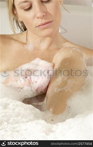 Close-up of a young woman in a bathtub