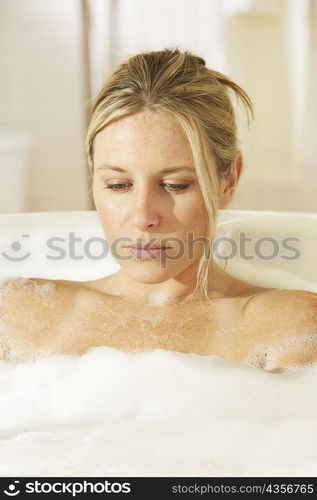 Close-up of a young woman in a bathtub