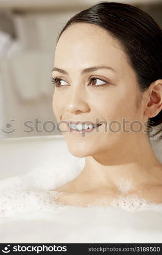 Close-up of a young woman in a bubble bath