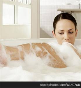 Close-up of a young woman in a bubble bath