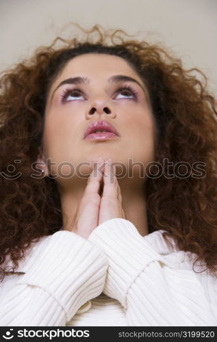 Close-up of a young woman in a prayer position