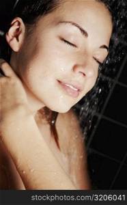Close-up of a young woman in the shower