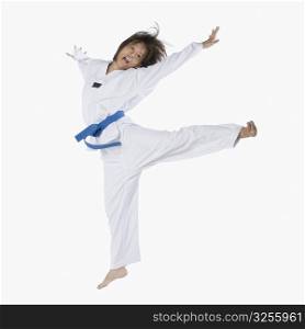 Close-up of a young woman jumping and practicing martial arts