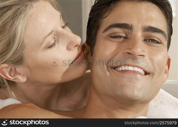 Close-up of a young woman kissing a young man