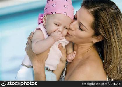 Close-up of a young woman kissing her daughter