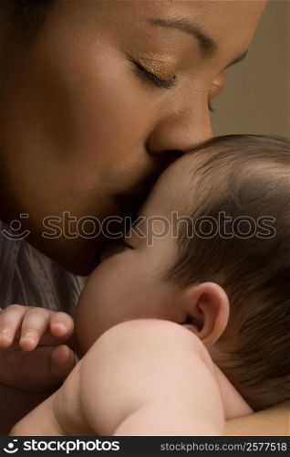 Close-up of a young woman kissing her son