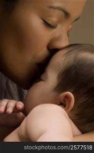 Close-up of a young woman kissing her son