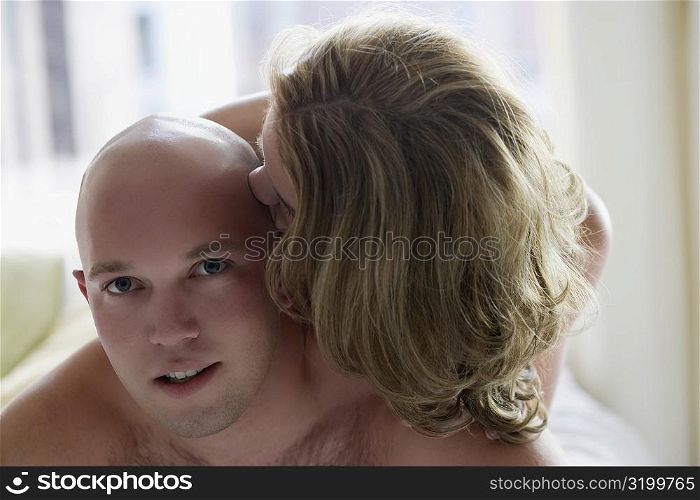 Close-up of a young woman kissing on a young man&acute;s head