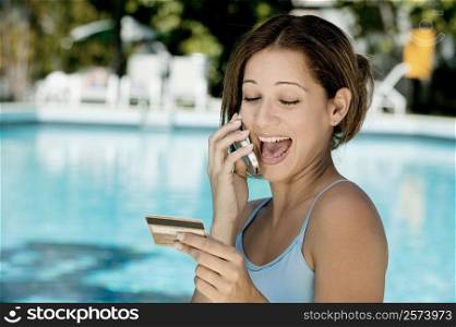 Close-up of a young woman laughing on a mobile phone