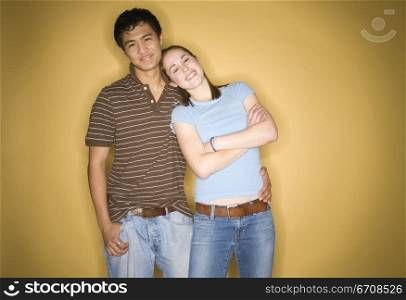 Close-up of a young woman leaning against a young man