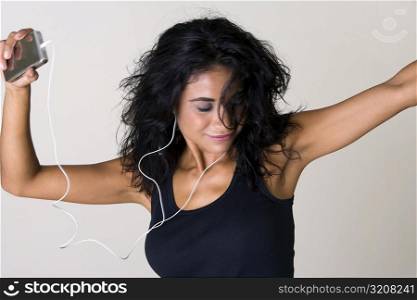 Close-up of a young woman listening to an MP3 Player