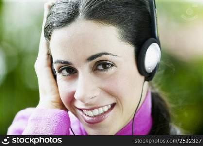 Close-up of a young woman listening to music