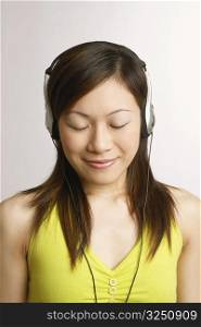 Close-up of a young woman listening to music