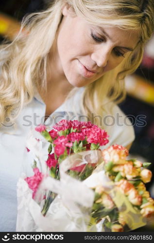 Close-up of a young woman looking at a bouquet of flowers