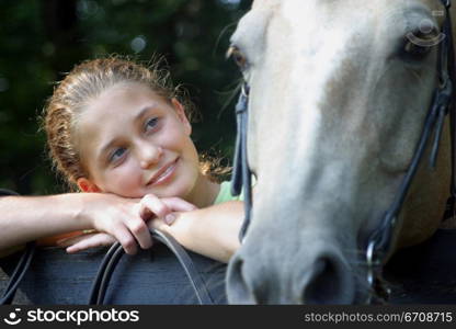 Close-up of a young woman looking at a horse